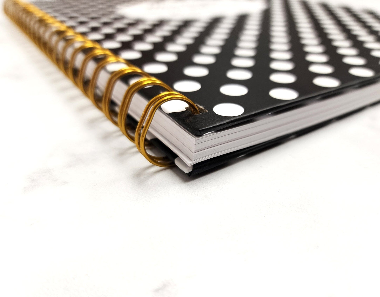 View of the hardcover corner and ring binding of the weekly lesson plan book. 