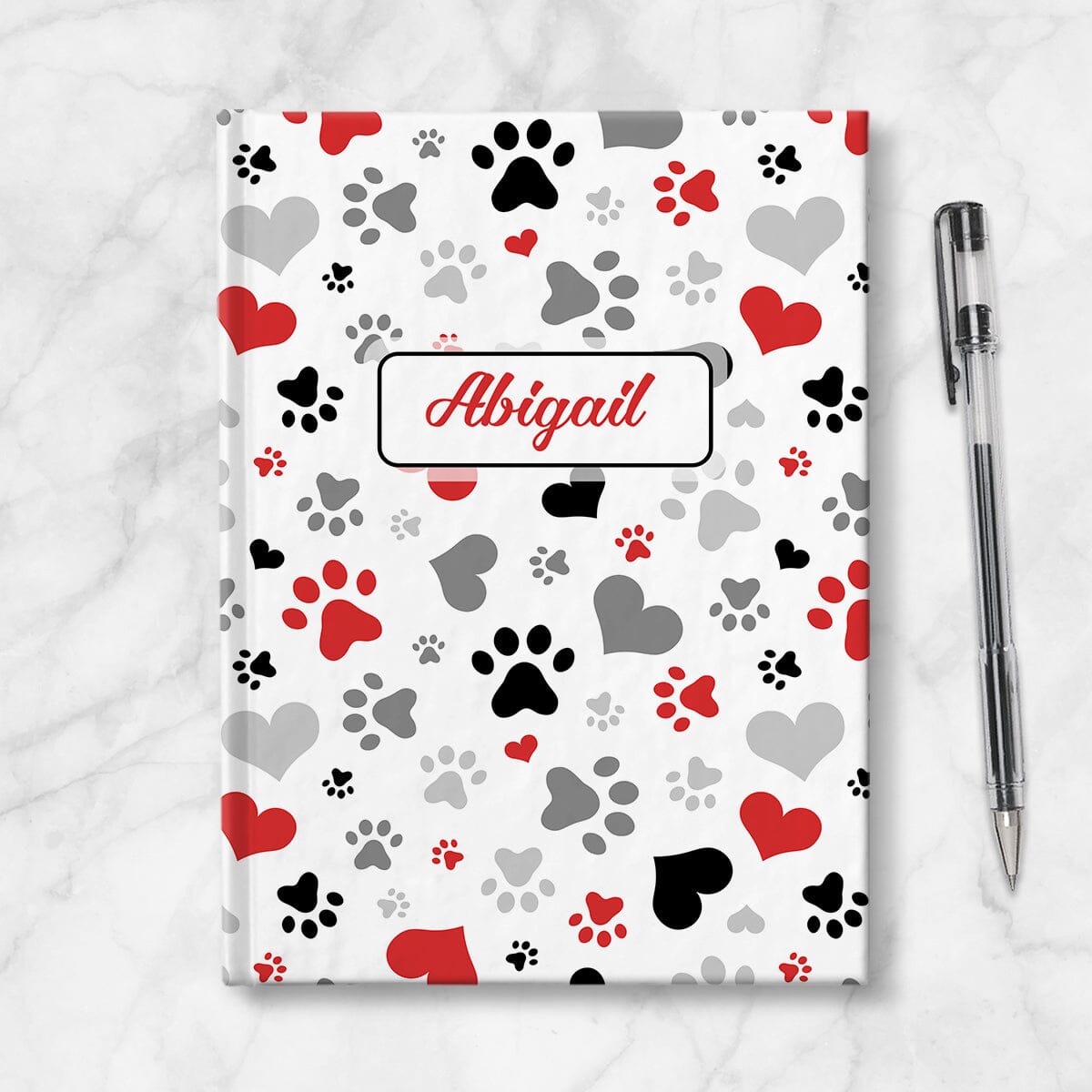 Personalized Black Red Hearts and Paw Prints Journal at Artistically Invited. Front side of journal on table with a pen next to it.