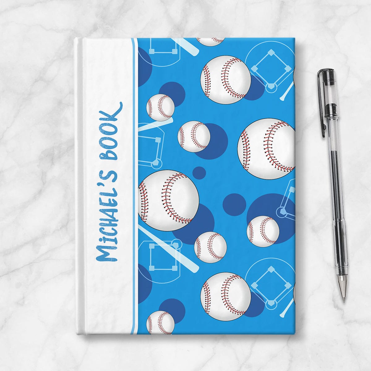 Personalized Blue Baseball Journal at Artistically Invited. Image shows the book on a countertop next to a pen.