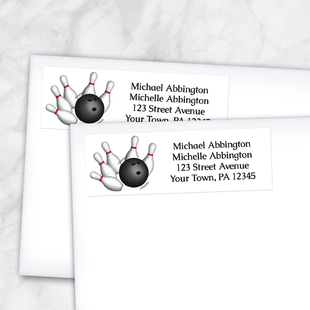 Bowling Ball and Pins Address Labels at Artistically Invited. Custom return address labels designed with a bowling illustration on the left side, featuring a bowling ball striking pins. Your personalized return address is custom printed in black to the right of the bowling design over a white background. Image shows two labels on envelopes.