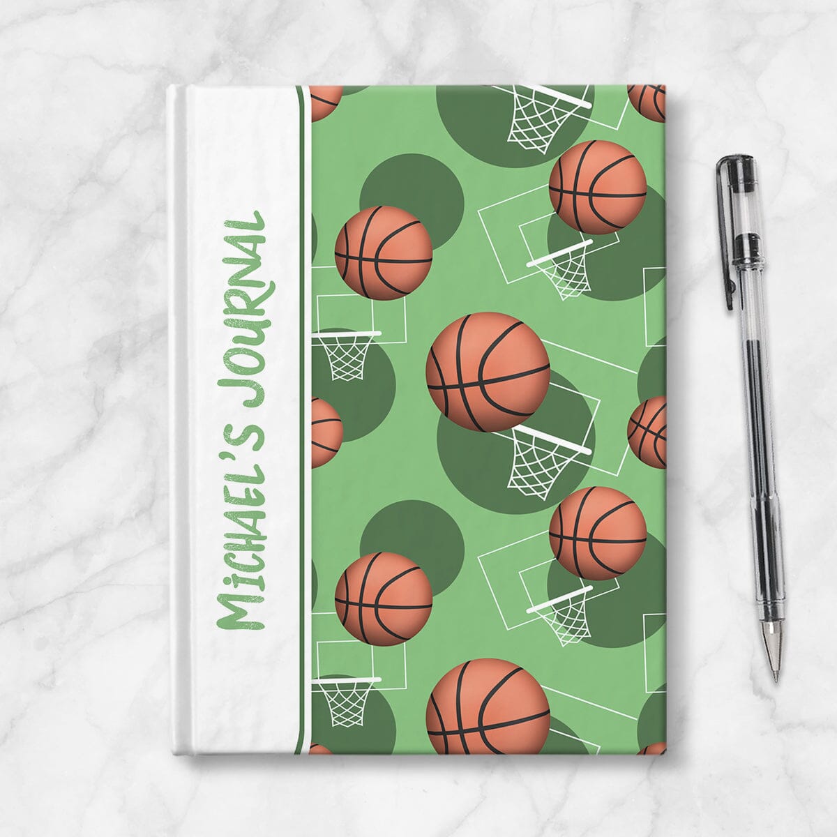 Personalized Green Basketball Journal at Artistically Invited. Image shows the book on a countertop next to a pen.