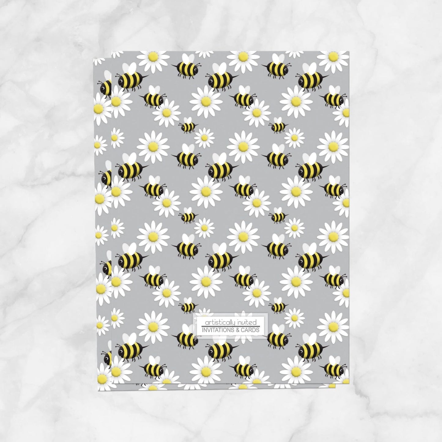 The backside of the invitations is printed with the bee and daisy pattern when the printed invitation upgrade is purchased