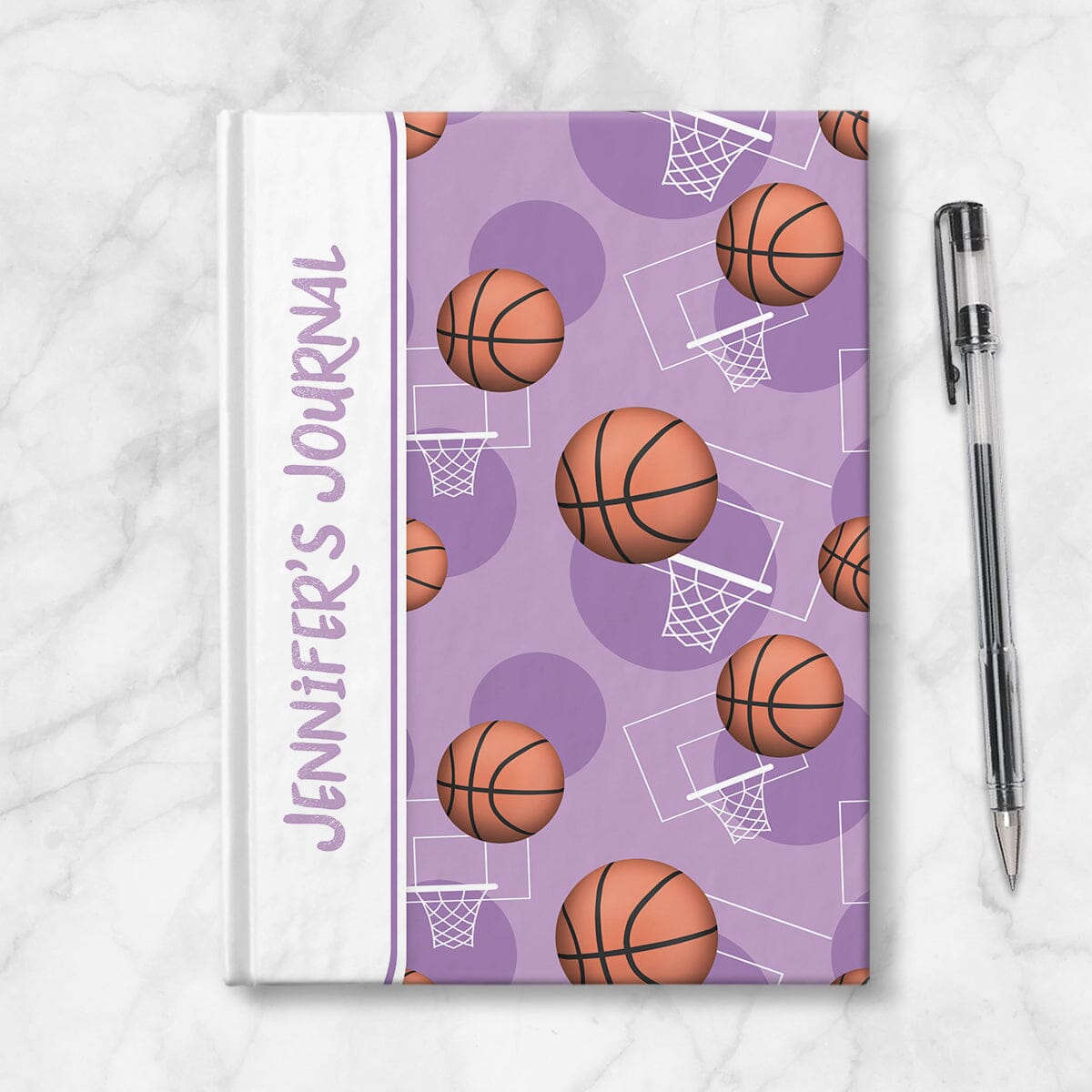 Personalized Purple Basketball Journal at Artistically Invited. Image shows the book on a countertop next to a pen.