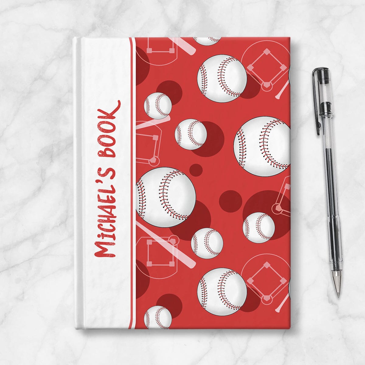 Personalized Red Baseball Journal at Artistically Invited. Image shows the book on a countertop next to a pen.