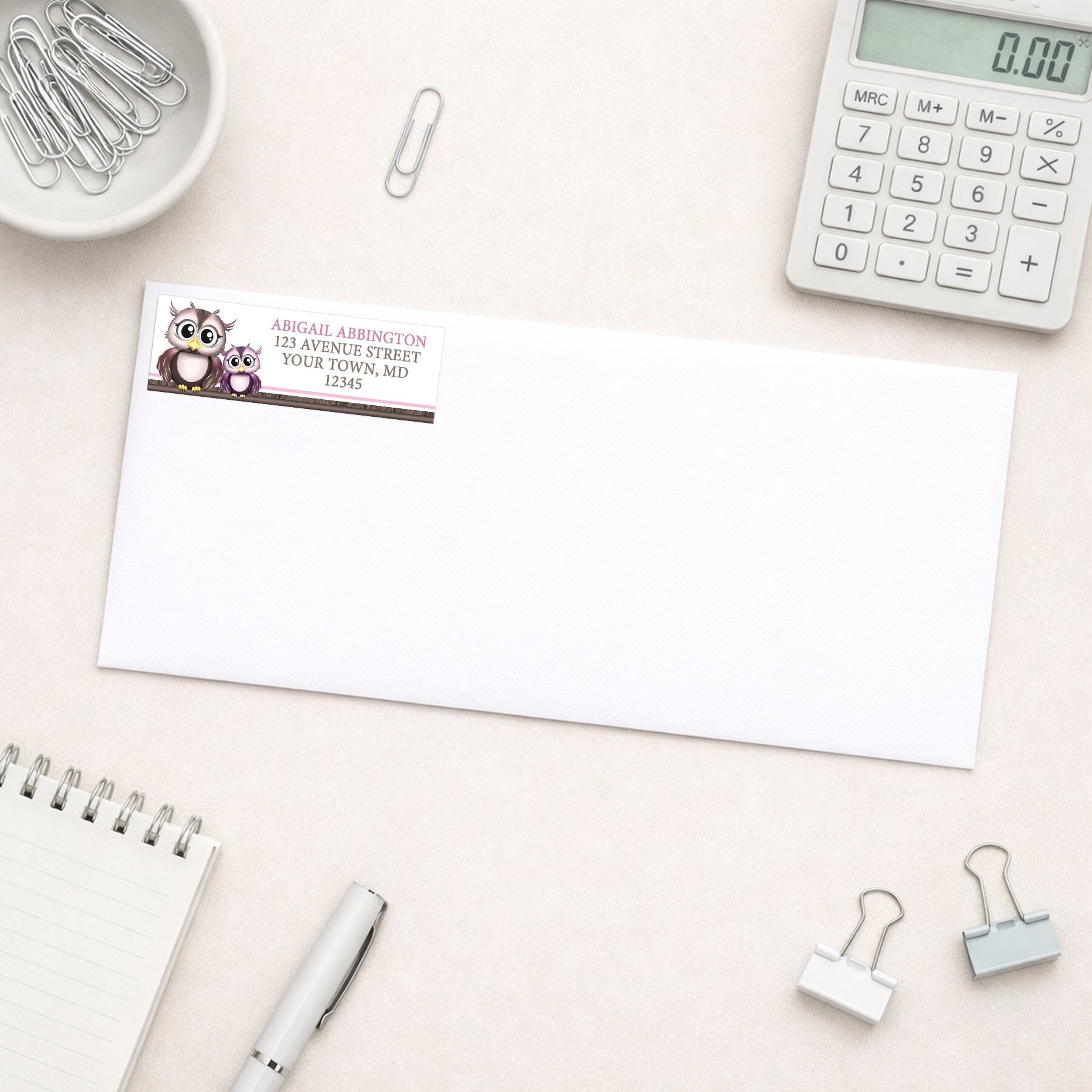 Adorable Pink Owl and Purple Baby Owl Address Label shown on a white envelope with everyday office supplies