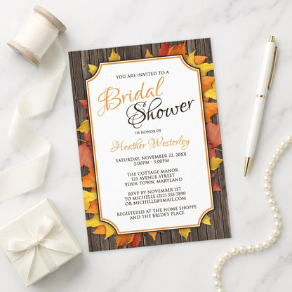 Autumn Orange White Wood Bridal Shower Invitation shown on a marble surface with a white gift box, pen, ribbon, and pearls.
