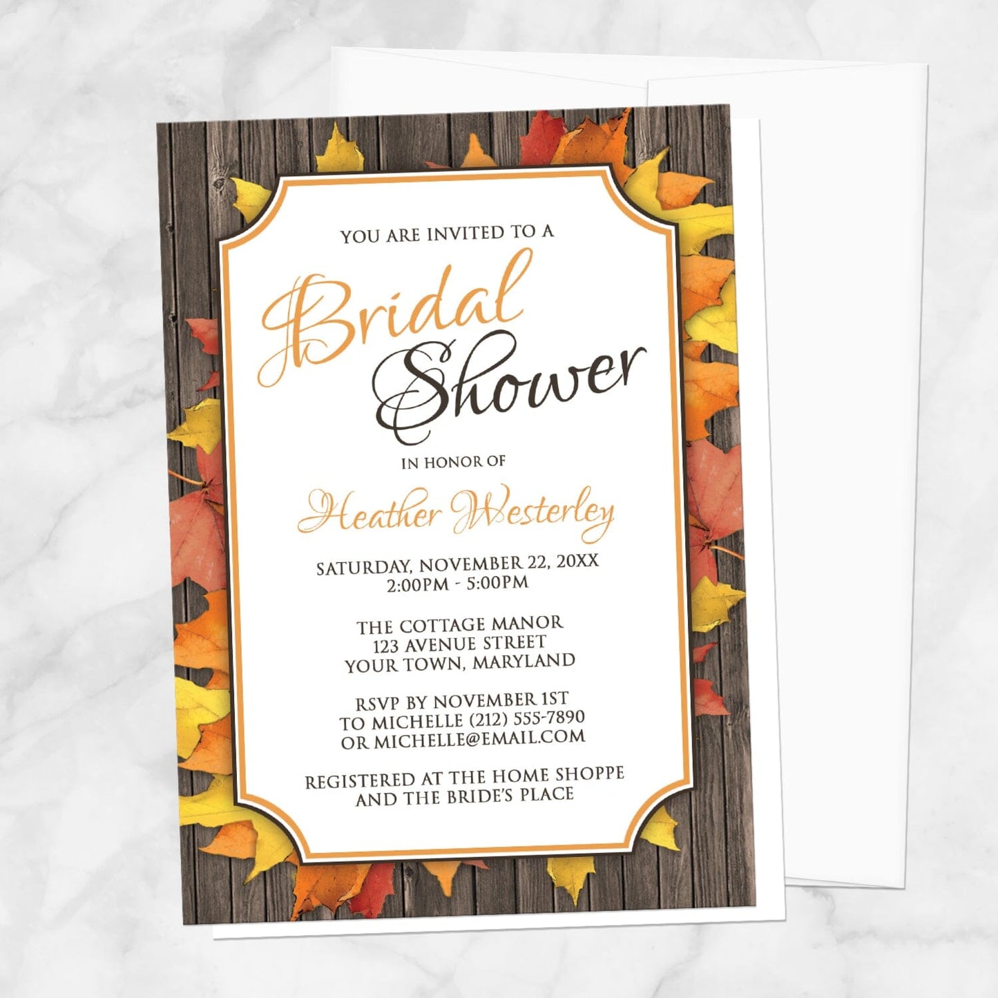 Autumn Orange White Wood Bridal Shower Invitation shown on a marble surface with a white envelope.