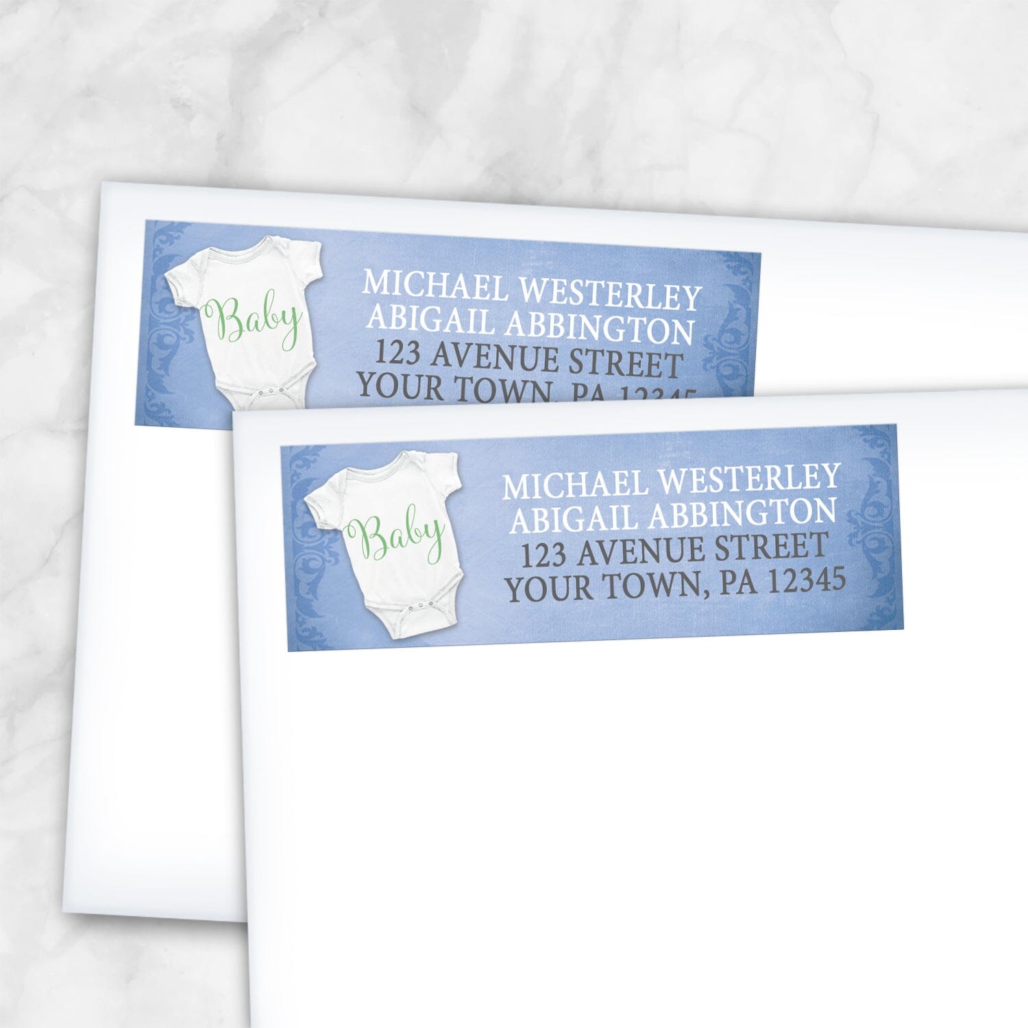 2 Baby Bodysuit on Blue Address Labels shown on white envelopes on a marble surface