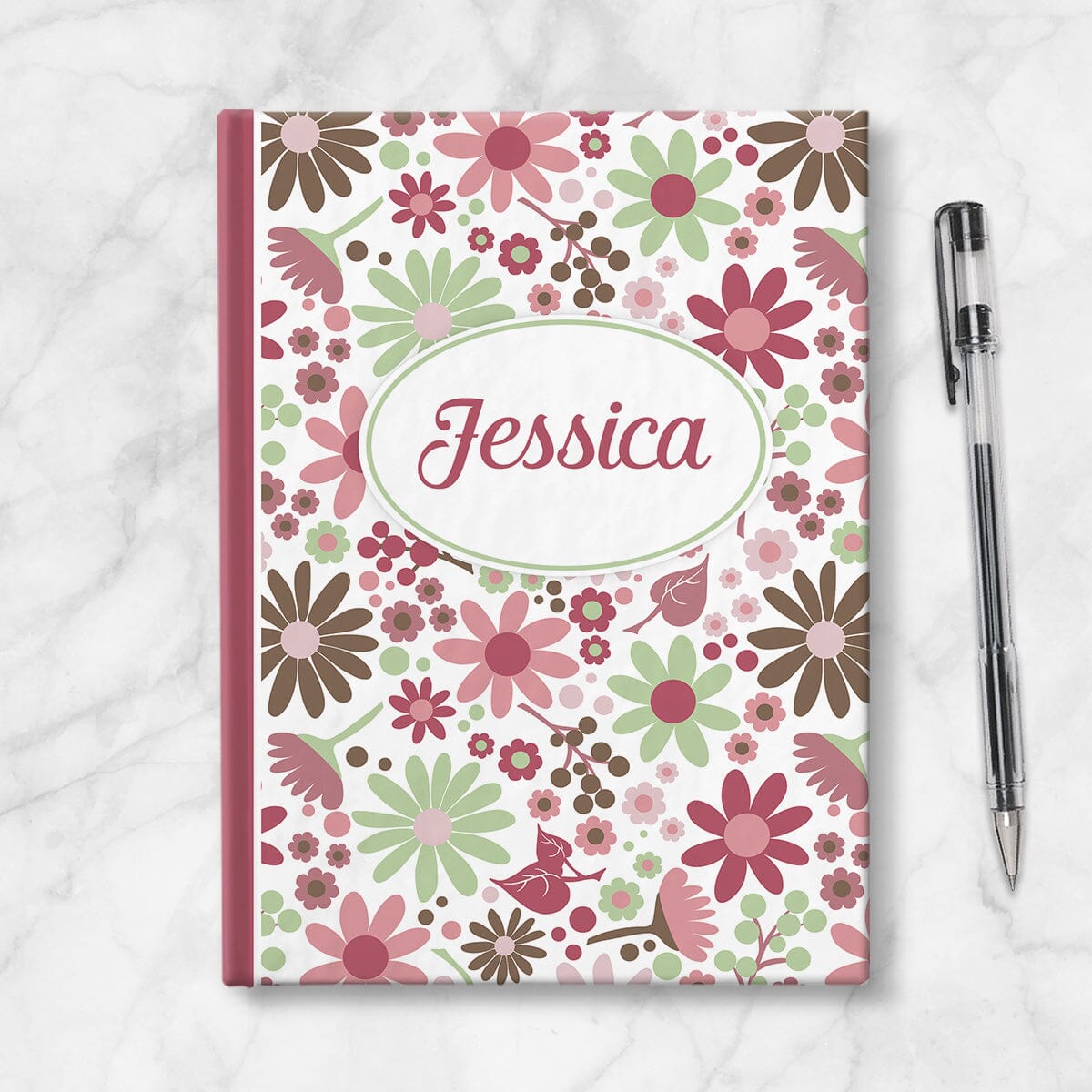 Personalized Berry Green Summer Flowers Journal at Artistically Invited. Image shows the book on a countertop next to a pen.