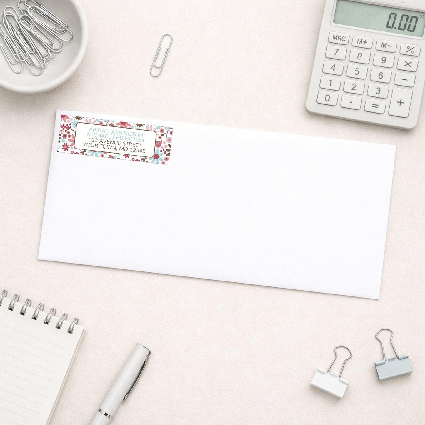 Berry Blue Summer Flowers Address Label shown on a white envelope with office supplies