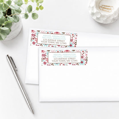 Berry Blue Summer Flowers Address Labels on white envelopes with a pen and plant on a white surface