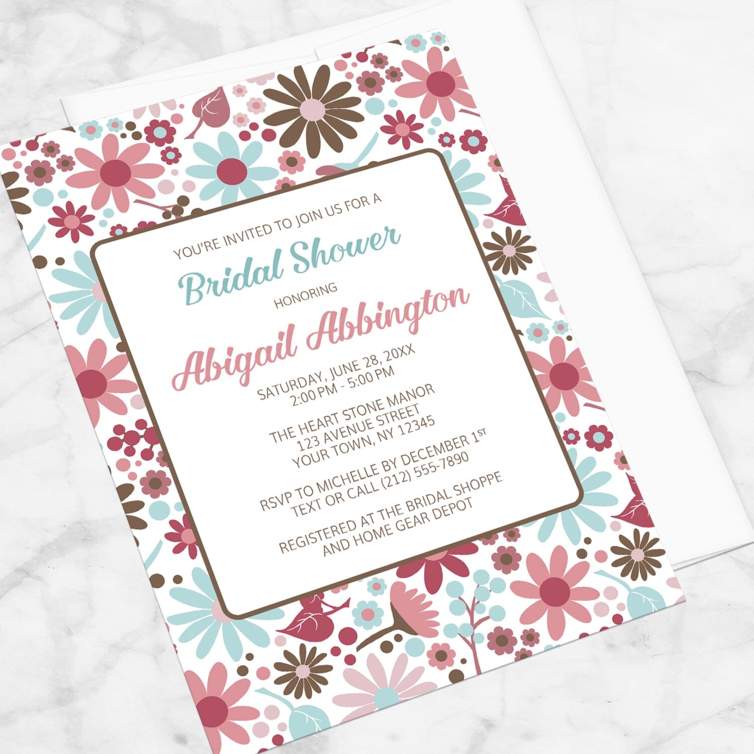 Berry Blue Summer Flowers Bridal Shower Invitation shown at an angle on a marble surface.