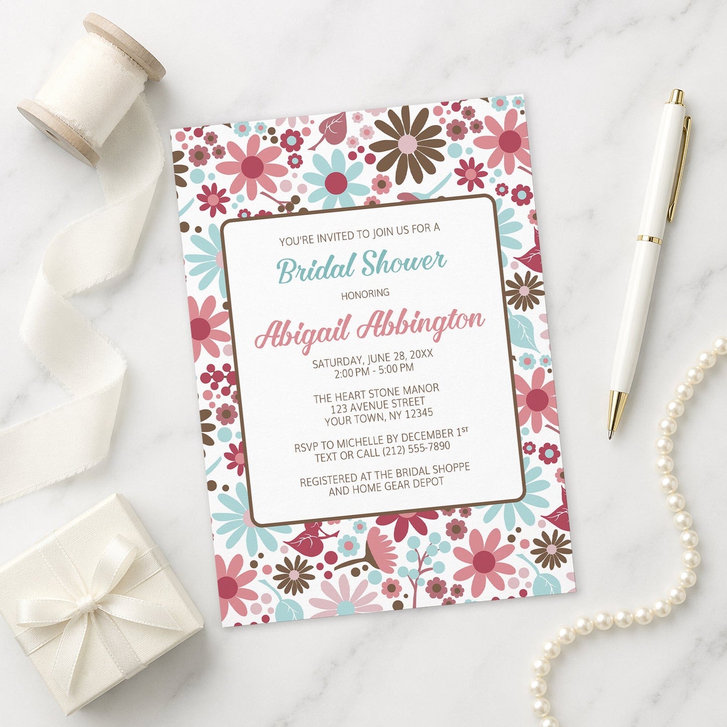 Berry Blue Summer Flowers Bridal Shower Invitation on a marble surface with ribbon, gift, and pen.