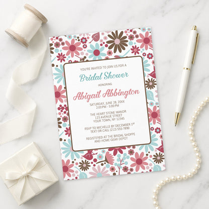 Berry Blue Summer Flowers Bridal Shower Invitation on a marble surface with ribbon, gift, and pen.
