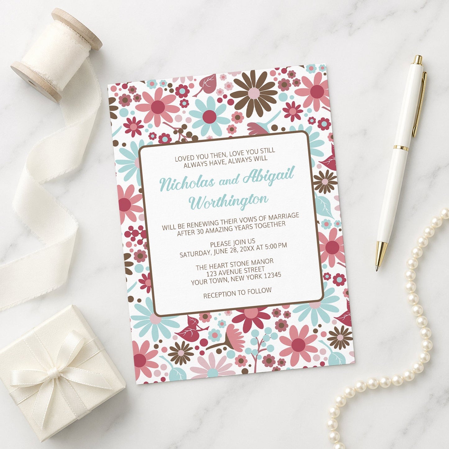 Berry Blue Summer Flowers Vow Renewal Invitation shown on a marble surface with a white gift box, pen, ribbon, and pearls.
