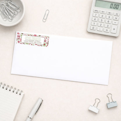 Berry Green Summer Flowers Address Label shown on a white envelope with everyday office supplies
