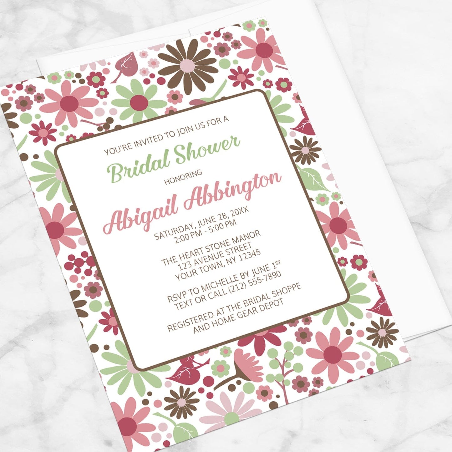 Berry Green Summer Flowers Bridal Shower Invitation shown at an angle on a marble surface.