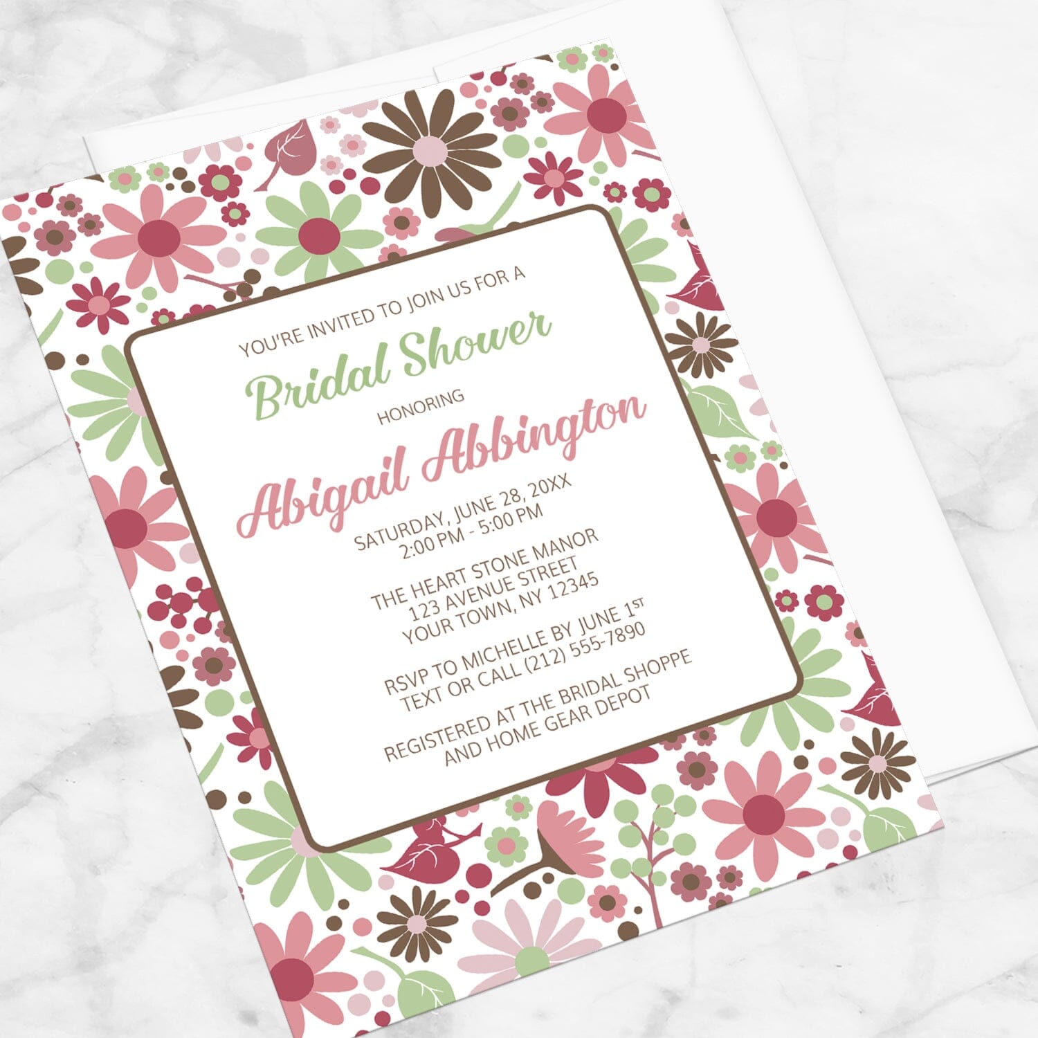 Berry Green Summer Flowers Bridal Shower Invitation shown at an angle on a marble surface.