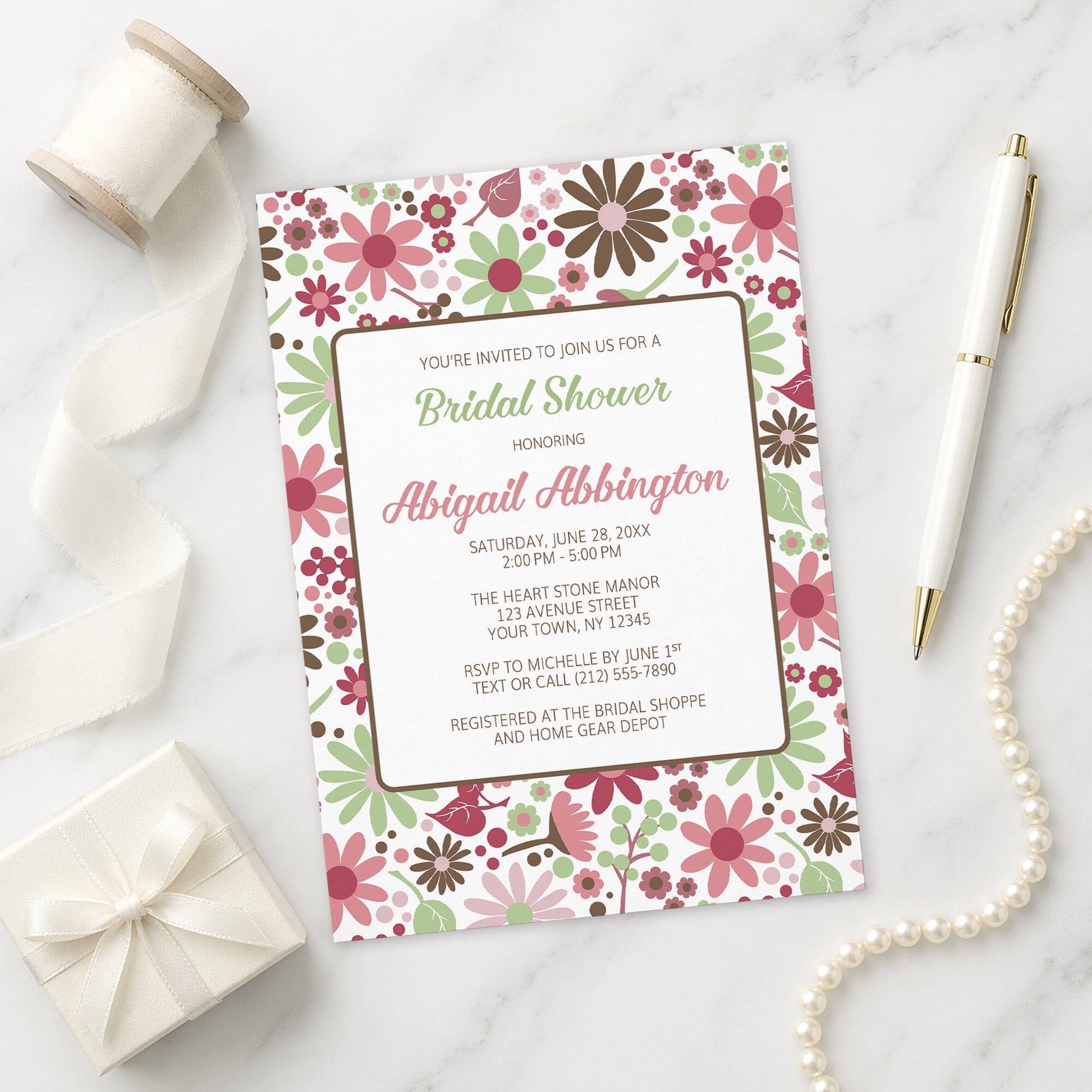 Berry Green Summer Flowers Bridal Shower Invitation on a marble surface with ribbon, gift, and pen.