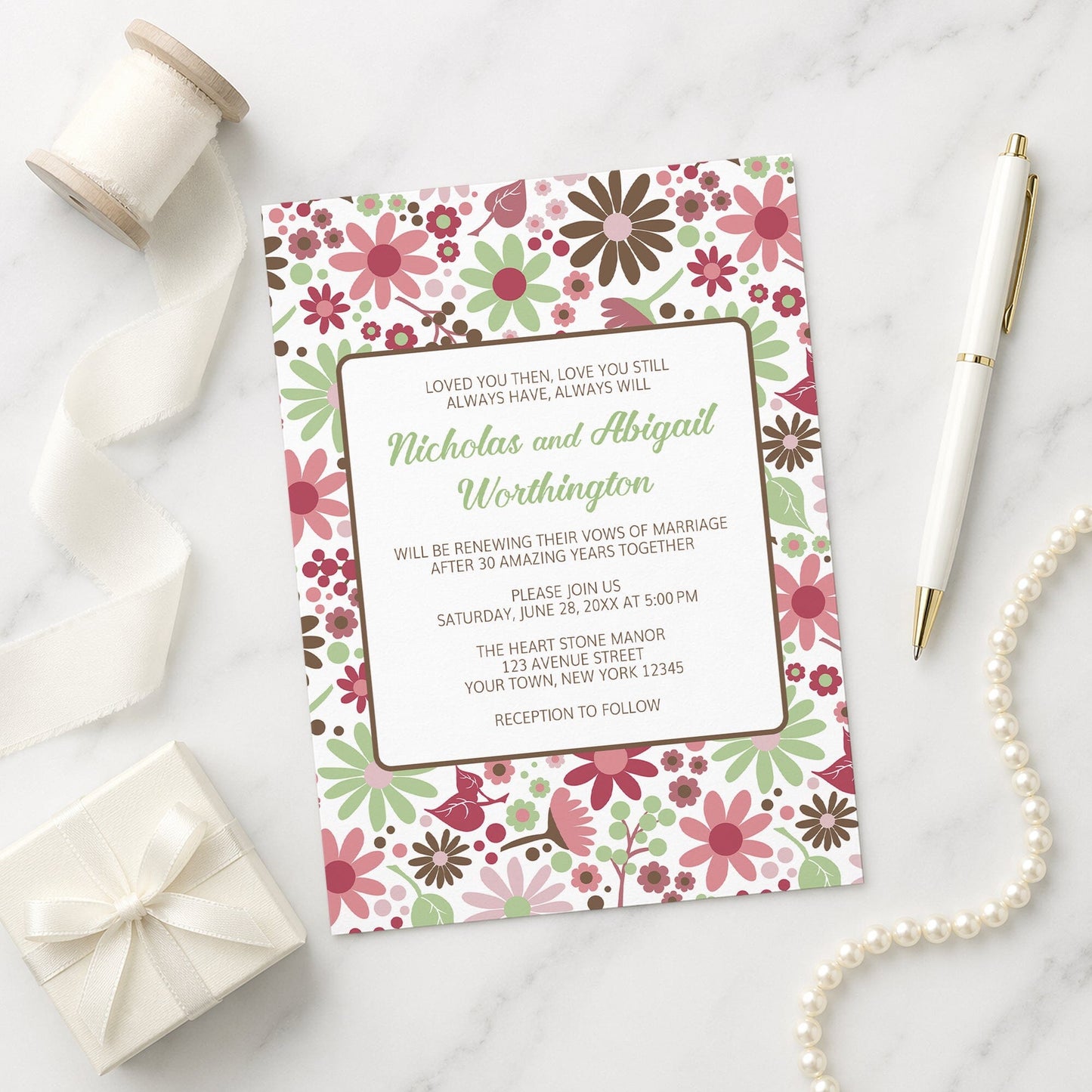 Berry Green Summer Flowers Vow Renewal Invitation shown on a marble surface with a white gift box, ribbon, pen, and pearls.