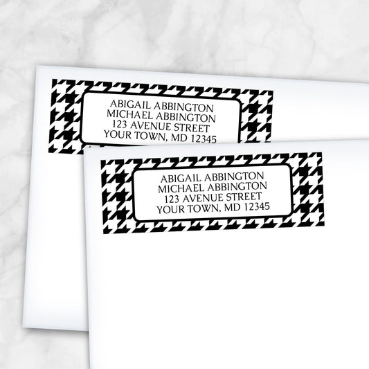 Two personalized Black and White Houndstooth Address Labels on white envelopes on a marble surface.