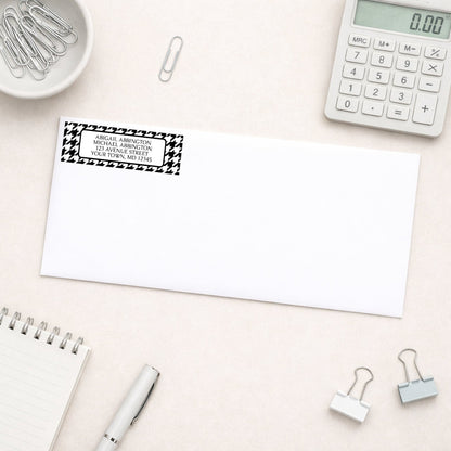Black and White Houndstooth Address Label on a white envelope on a desk with office supplies.
