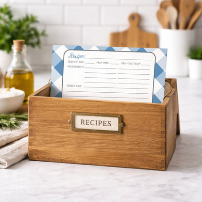 Wooden recipe box with a Blue Gingham Recipe Card on top, kitchen setting in the background
