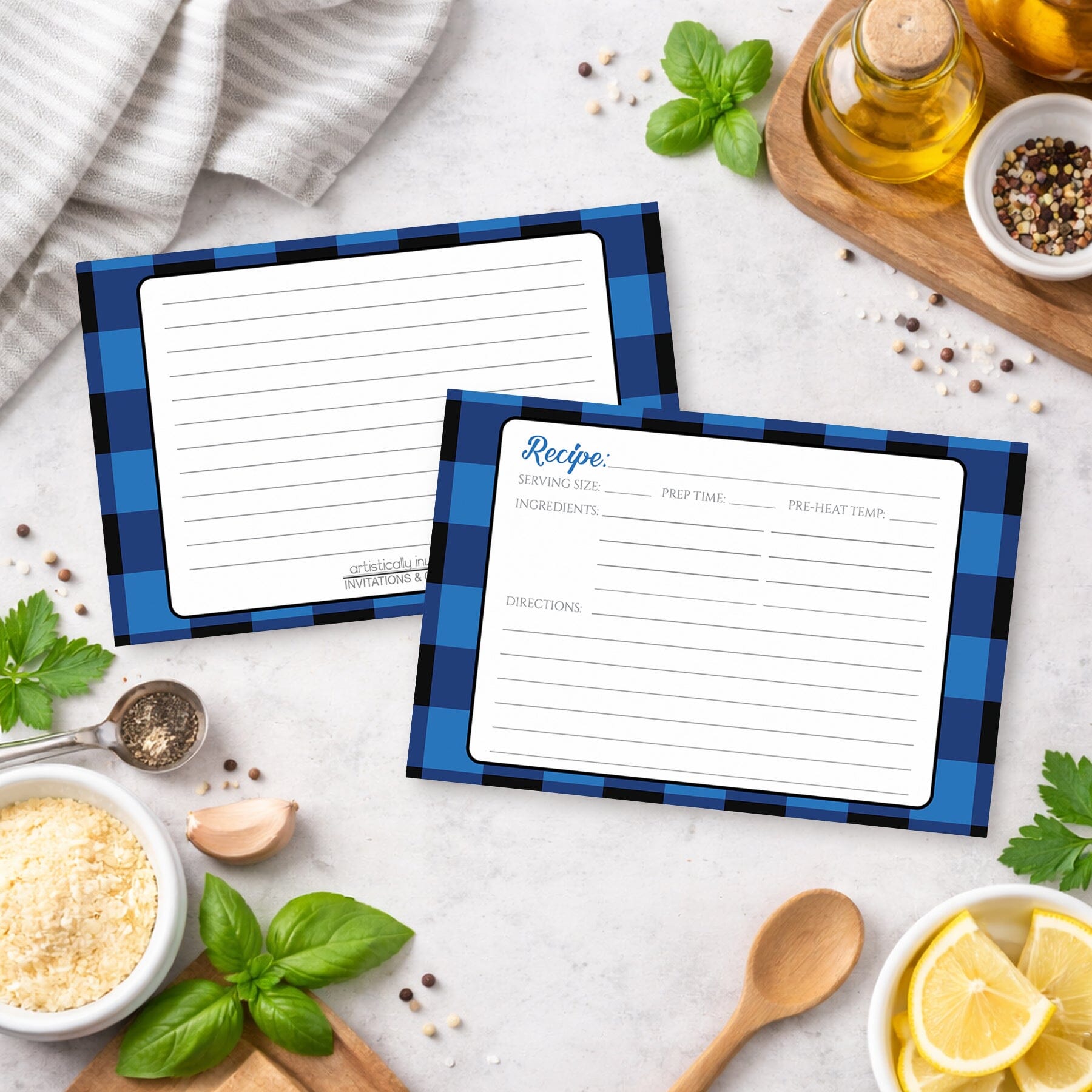 Two Blue and Black Buffalo Plaid Recipe Cards with blue checkered borders on a kitchen counter with ingredients.