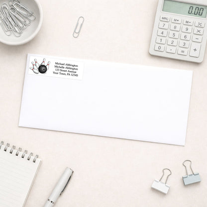 Bowling Ball and Pins Address Label shown on a white envelope with everyday office supplies
