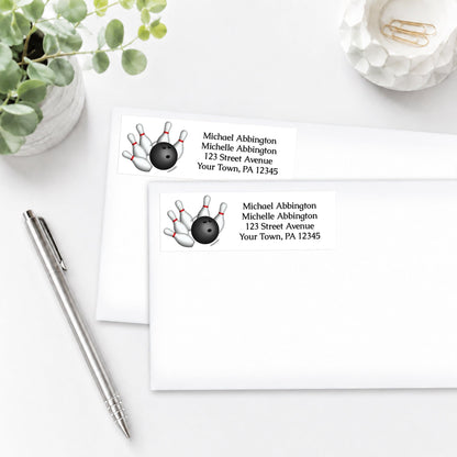Address labels with bowling design, shown on white envelopes, on a white surface with a pen and plant.