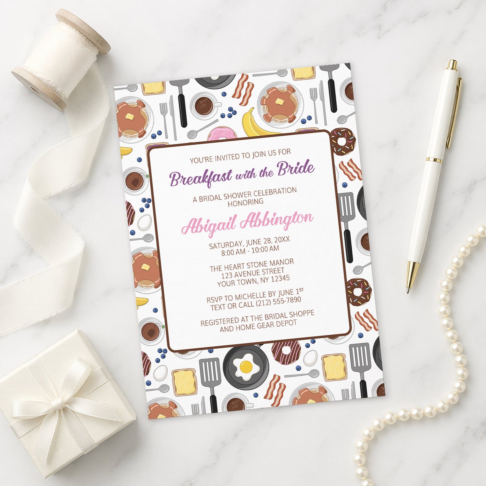 Breakfast with the Bride Bridal Shower Invitation on a marble surface with decorative items.