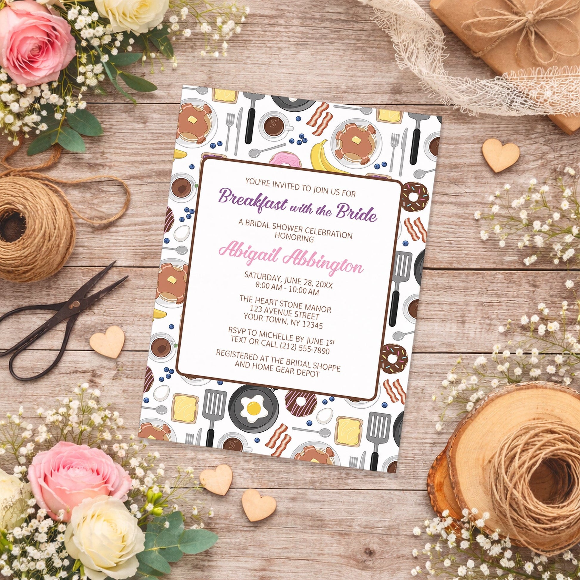 Breakfast with the Bride Bridal Shower Invitation with breakfast-themed design on a wooden surface with flowers and twine.