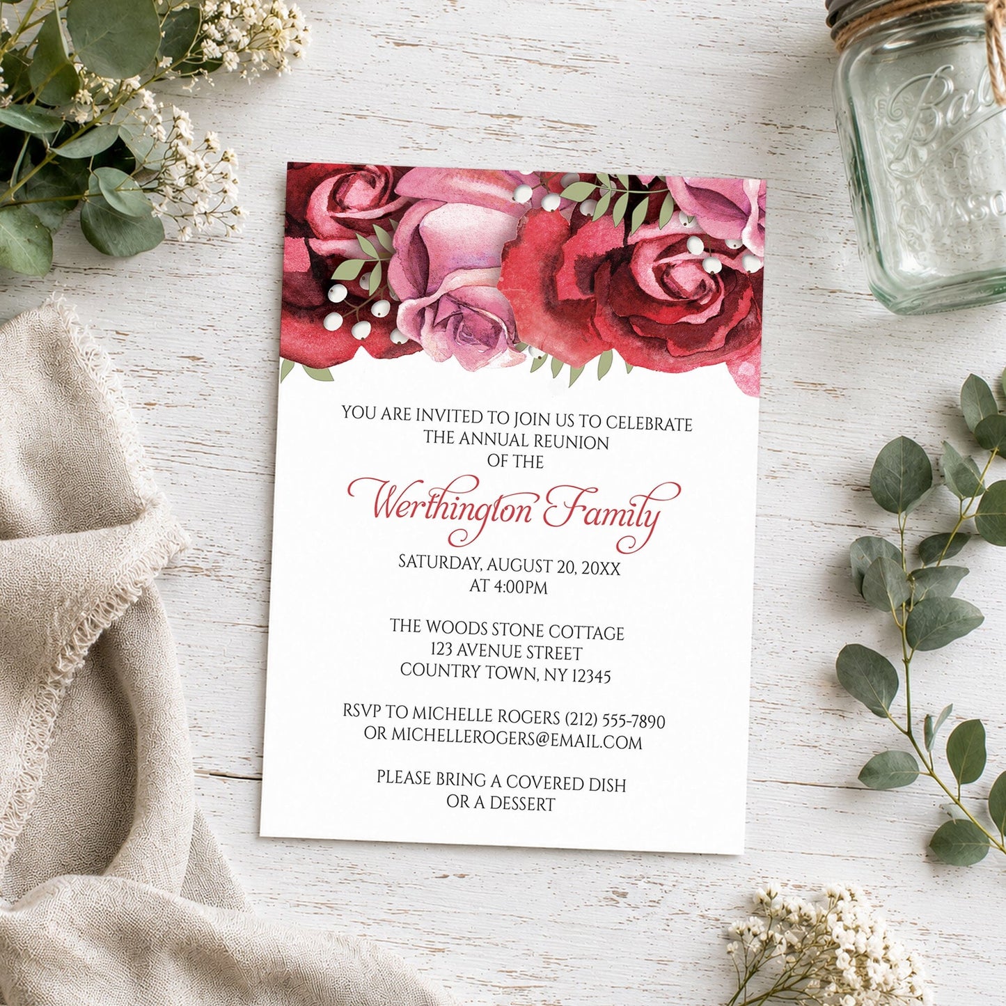 Burgundy Red Pink Rose Family Reunion Invitation shown on a wooden surface with plants and a small mason jar.