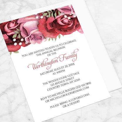 Burgundy Red Pink Rose Family Reunion Invitation shown at an angle on a marble surface with a white envelope.