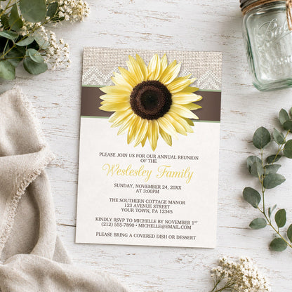 Burlap Lace Brown Sage Sunflower Family Reunion Invitation shown on a light wood surface with plants and a small mason jar.