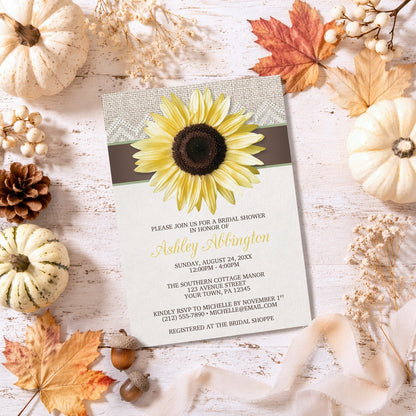 Burlap Lace Brown Sunflower Bridal Shower Invitation surrounded by autumn decorations on a wooden surface.