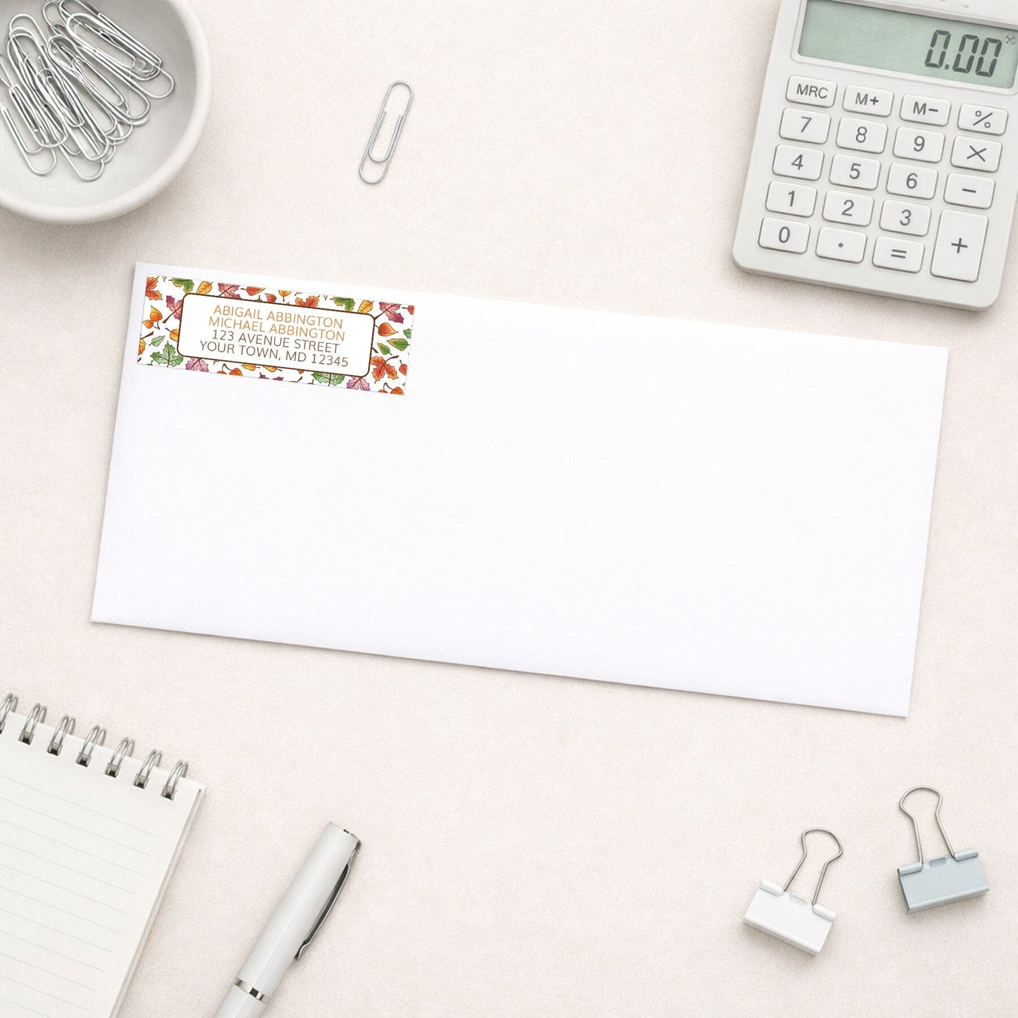 Changing Leaves Fall Address Label shown on a white envelope with office supplies