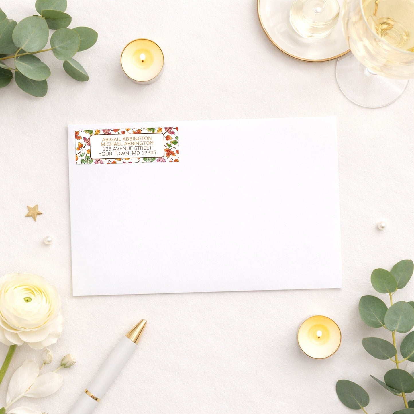 Changing Leaves Fall Address Label shown on a white envelope with wedding supplies