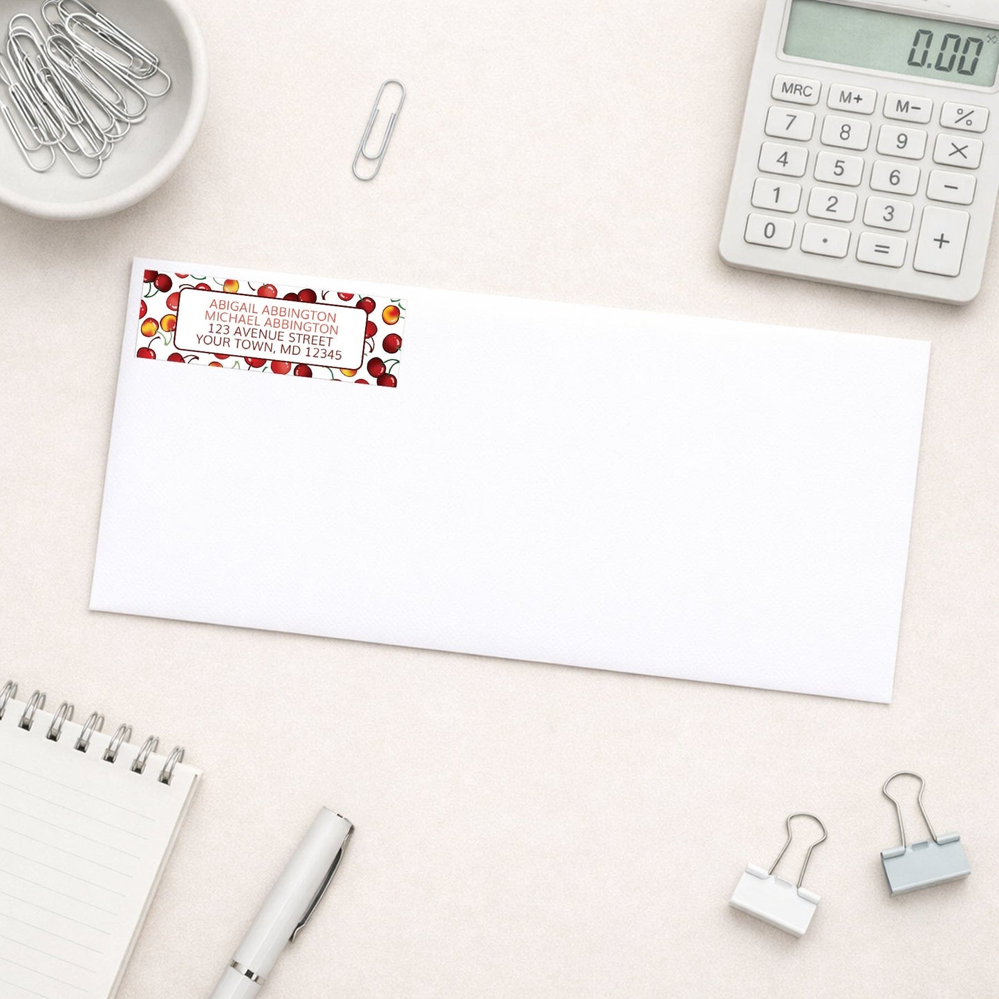 Cherries Address Label shown on a white envelope with office supplies