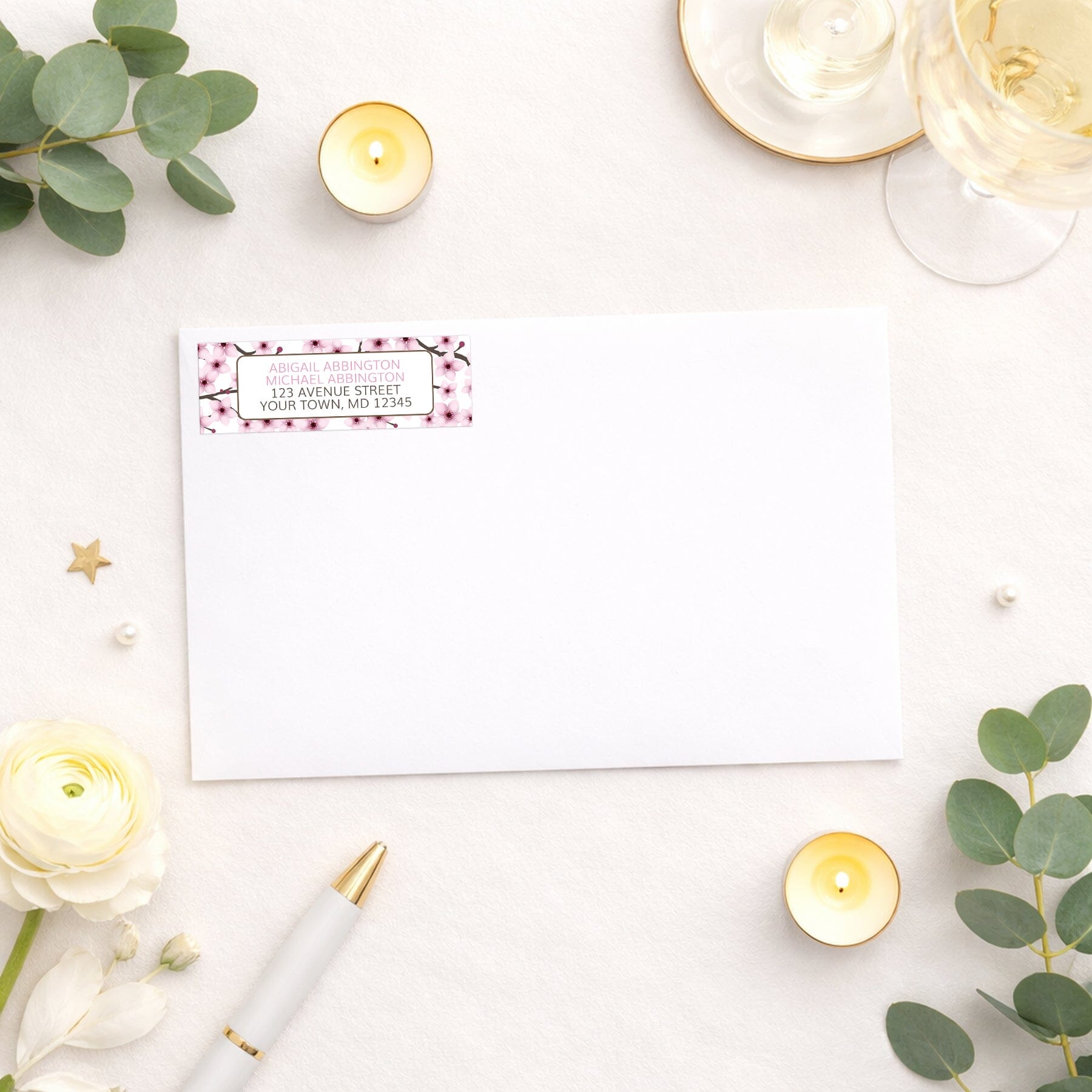 Cherry Blossom Address Label shown on a white envelope with wedding supplies