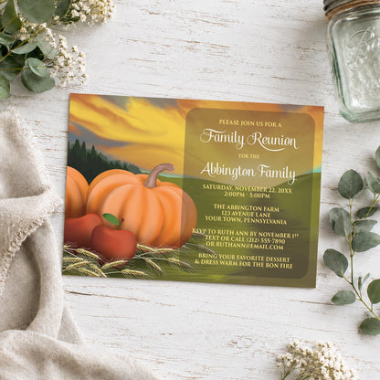 Country Autumn Harvest Family Reunion Invitation shown on a wooden surface with plants and a small mason jar.