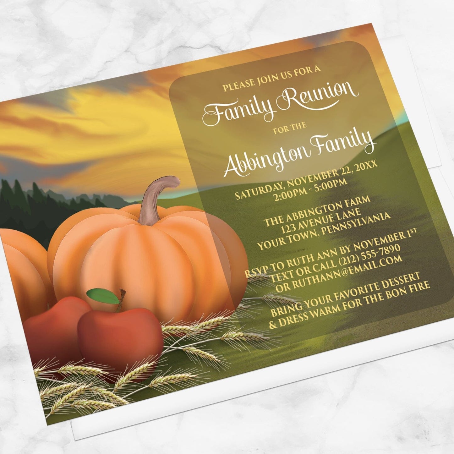 Country Autumn Harvest Family Reunion Invitation shown at an angle on a marble surface with a white envelope.