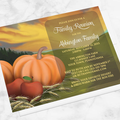 Country Autumn Harvest Family Reunion Invitation shown at an angle on a marble surface with a white envelope.