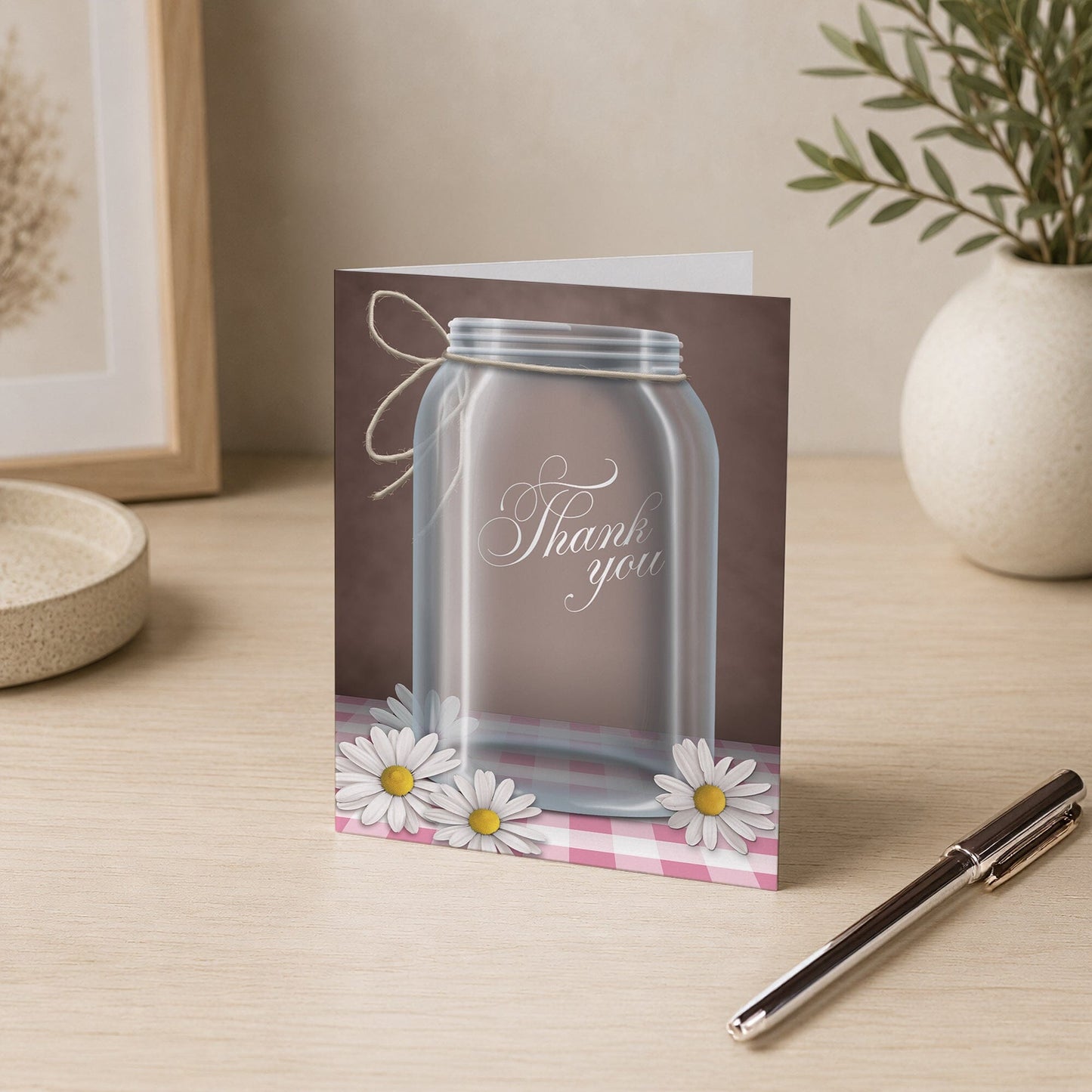 Country Mason Jar Daisy Gingham Thank You Card on a desk with a vase and a pen.