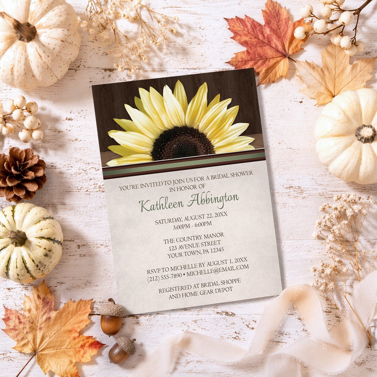 Country Sunflower Over Wood Rustic Bridal Shower Invitation shown on a pained wooden surface with fall leaves and autumn decor.
