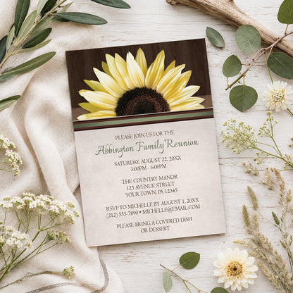 Country Sunflower Over Wood Rustic Family Reunion Invitation shown on a wooden surface with spring and summer plants.