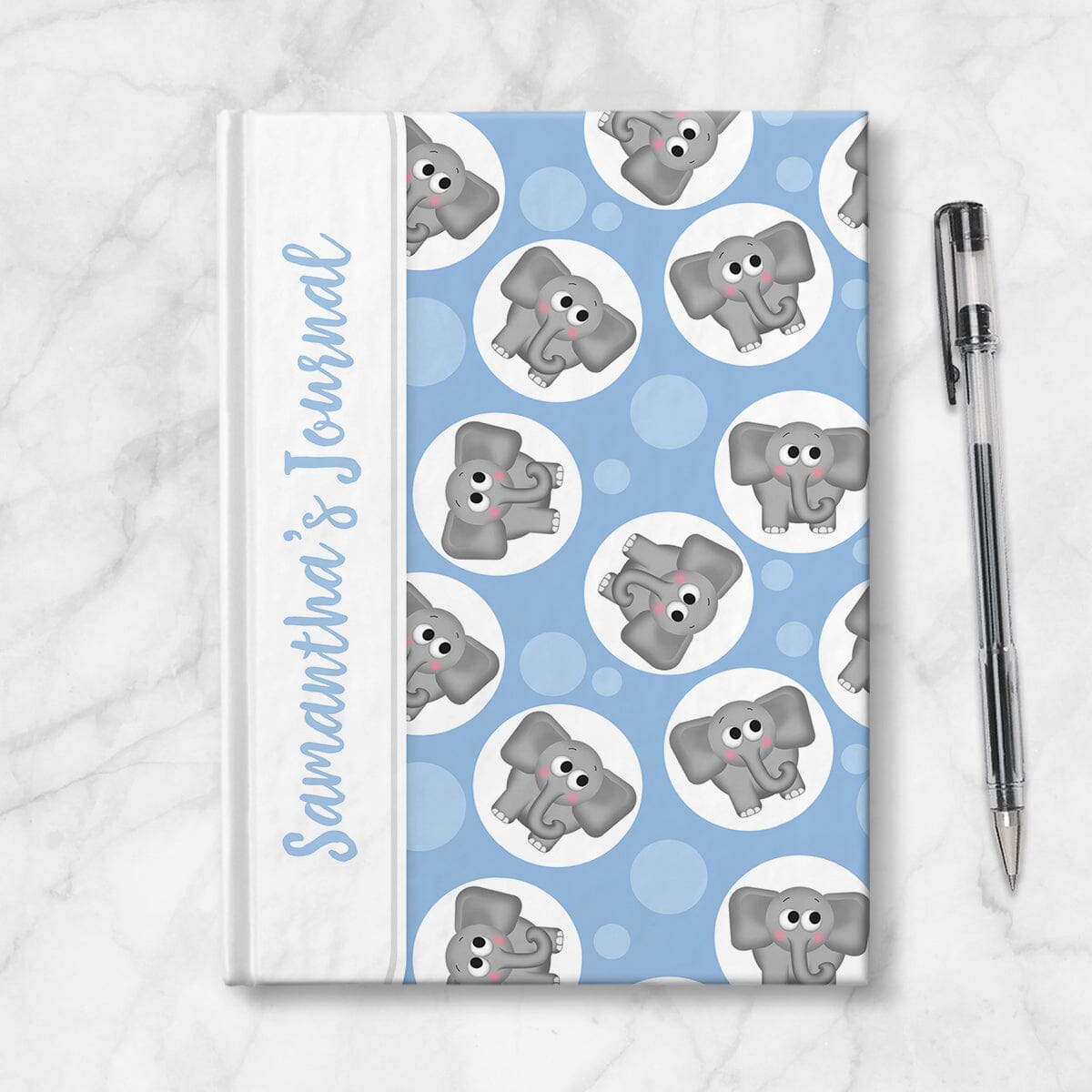 Personalized Cute Blue Elephant Journal at Artistically Invited. Image shows the book on a countertop next to a pen.