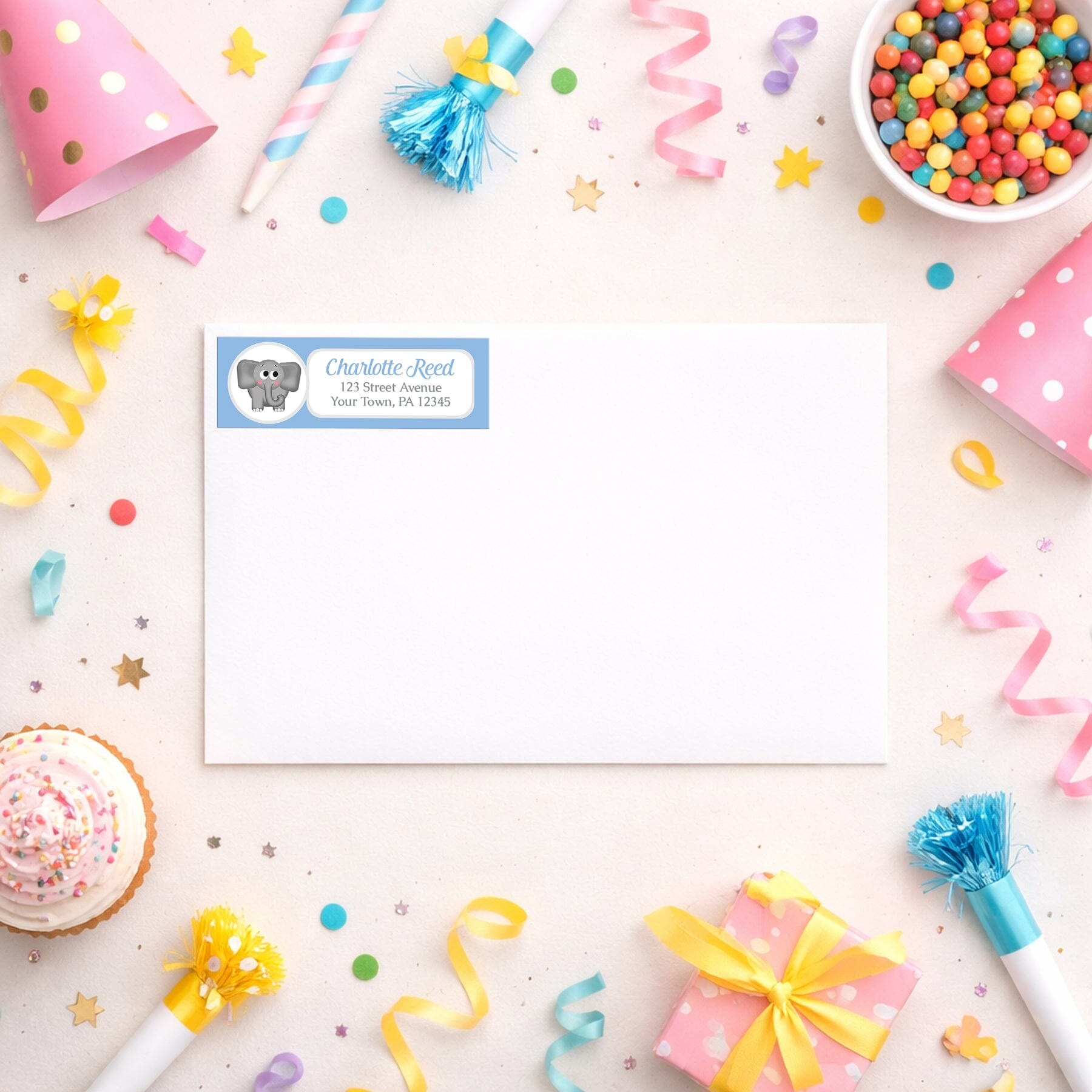 Cute Elephant Blue Address Label shown on a white envelope with party supplies