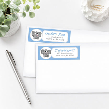 Cute Elephant Blue Address Labels, shown on white envelopes, on a white surface with a pen and plant.