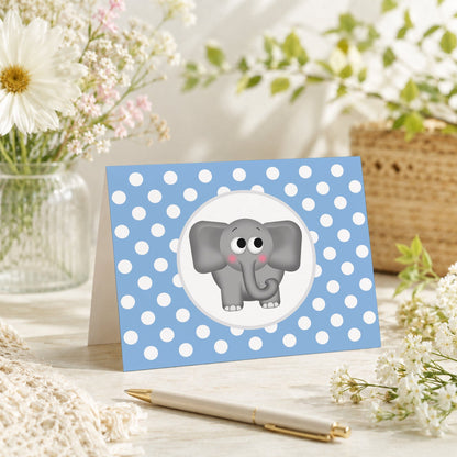 Cute Elephant Blue Polka Dot Note Card shown on a tabletop with a vase, spring and summer flowers, and a pen.